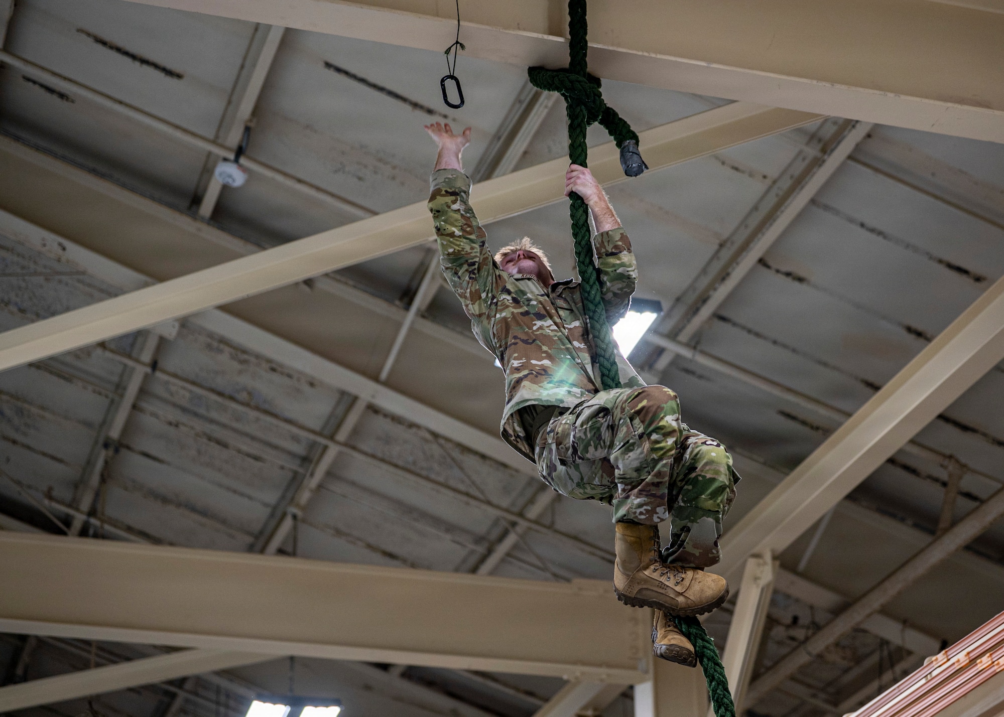 A U.S. Air Force Airman assigned to the 23d Combat Air Base Squadron climbs a rope at Moody Air Force Base, Georgia, Jan. 7, 2026. The rope climb assessed upper-body strength and technique during an assessment conducted to prepare volunteers for the Army Air Assault Course. (U.S. Air Force photo by Senior Airman Leonid Soubbotine)