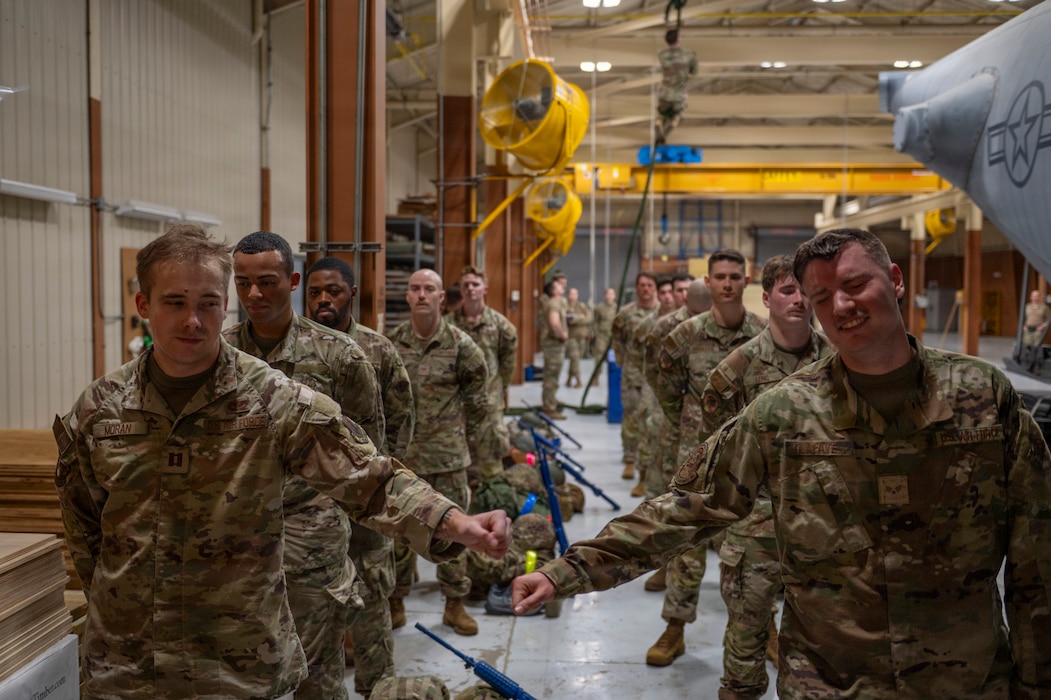 U.S. Air Force Airmen assigned to the 23d Combat Air Base Squadron wait for their turn to climb a rope at Moody Air Force Base, Georgia, Jan. 7, 2026. Airmen completed the rope climb as part of an assessment designed to measure physical aptitude prior to attending the Army Air Assault Course. (U.S. Air Force photo by Senior Airman Leonid Soubbotine)