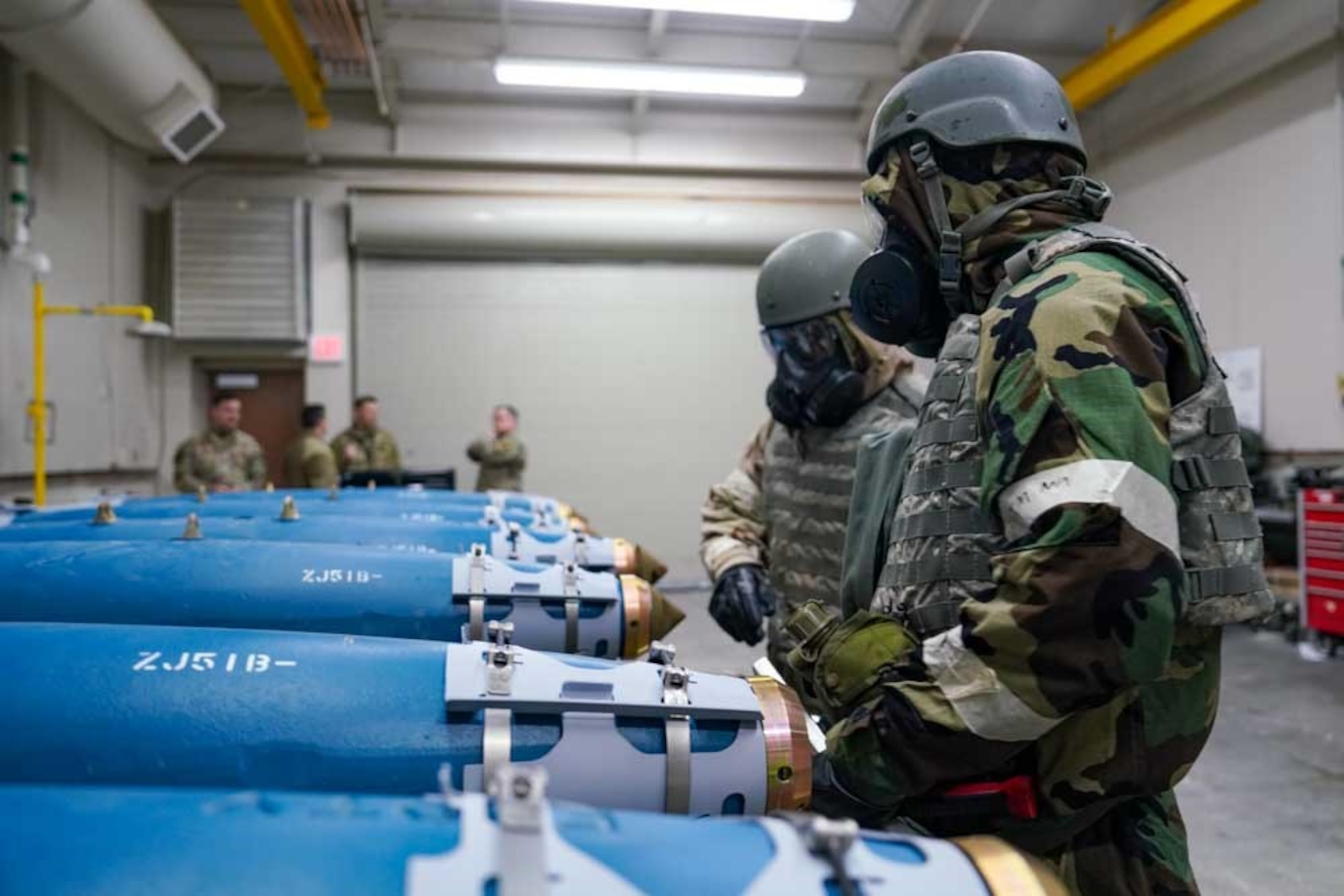 From the right, U.S. Air Force Staff Sgt. Julian Ortiz, 25th Maintenance Squadron conventional maintenance crew chief, and Airman Jared Ortiz, 25th MXS conventional maintenance technician, work an assembly line building inert GBU-38 Joint Direct Attack Munitions  during exercise Iron Raven at Creech Air Force Base, Nevada,  Nov. 19, 2025.
