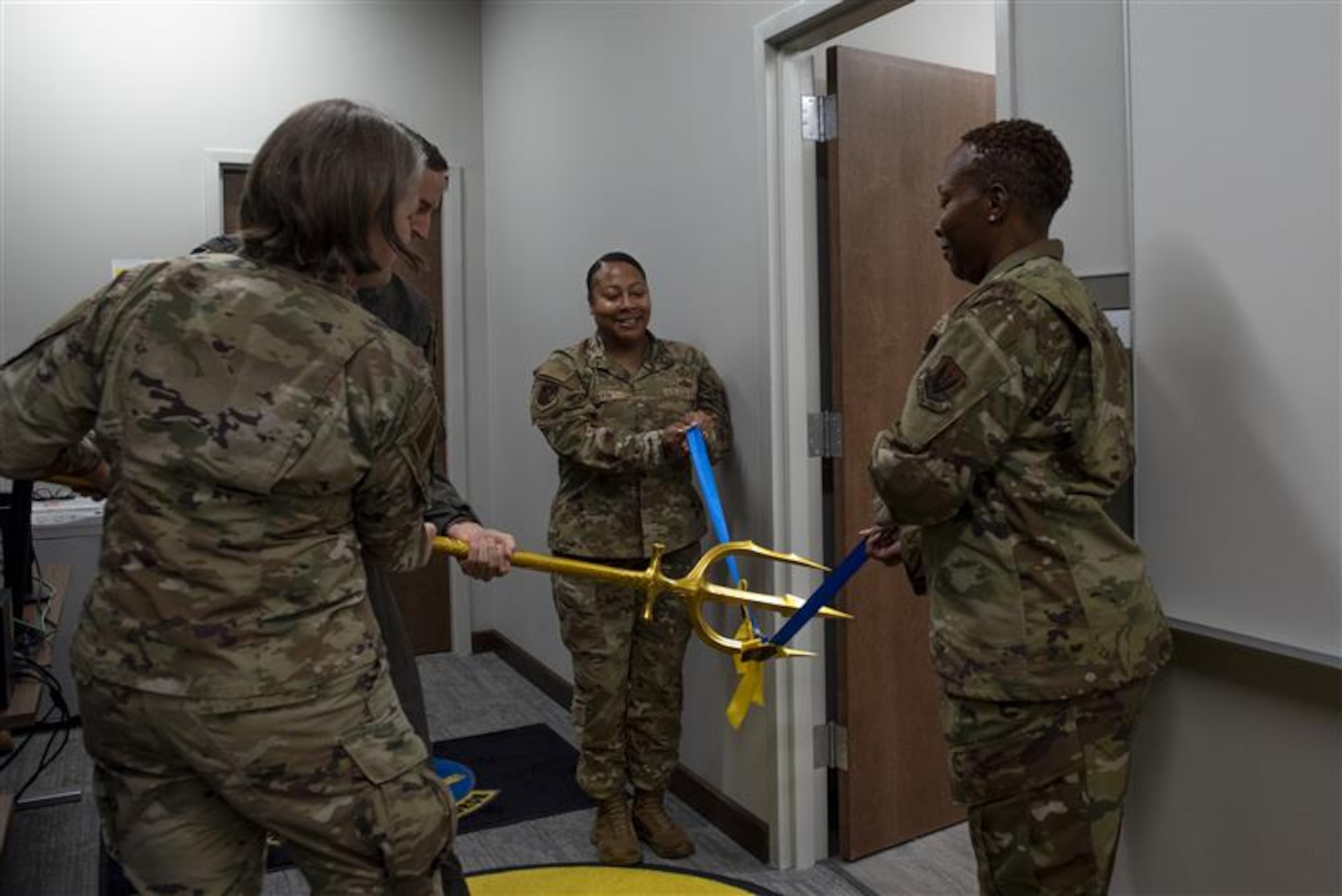 From the left, U.S. Air Force Col. Elizabeth Bowman, 20th Medical Group commander, Col. Brad Howell, 25th Attack Wing commander, Chief Master Sgt. Joanna Martin, 25th ATKW command chief, and Chief Master Sgt. Kalin Jones, 20th MDG senior enlisted leader, participate in a ribbon cutting ceremony at Shaw Air Force Base, S.C, Nov. 4, 2025.