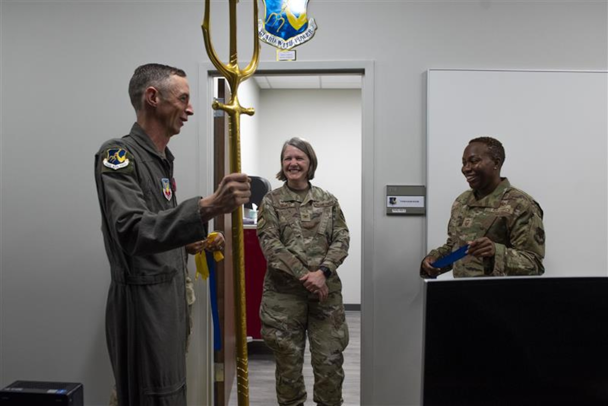 From left, U.S. Air Force Col. Brad Howell, 25th Attack Wing commander, Col. Elizabeth Bowman, 20th Medical Group commander, and Chief Master Sgt. Kalin Jones, 20th MDG senior enlisted leader, smile during a ribbon cutting ceremony at Shaw Air Force Base, S.C, Nov. 4, 2025.