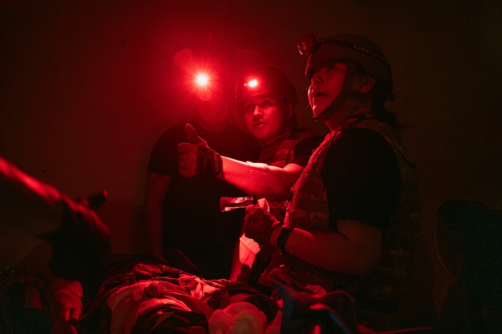U.S. Air Force Airman 1st Class Rafael Diaz, left, an aerospace medical technician and Staff Sgt. Danielle Dan, right, a health services management craftsman, both assigned to the 99th Medical Group, reassess patient care during the 2025 Diamondback Medic Rodeo at Nellis Air Force Base, Nevada, Dec. 9, 2025.