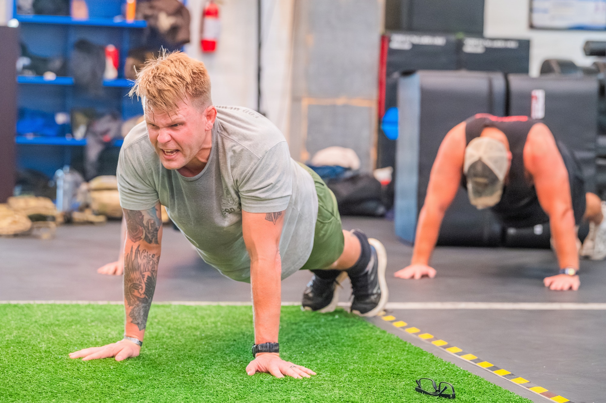 U.S. Air Force Staff Sgt. James Webb, 56th Civil Engineer Squadron explosive ordnance disposal technician, performs memorial push-ups during an annual memorial workout, Dec. 19, 2025, at Luke Air Force Base, Arizona.