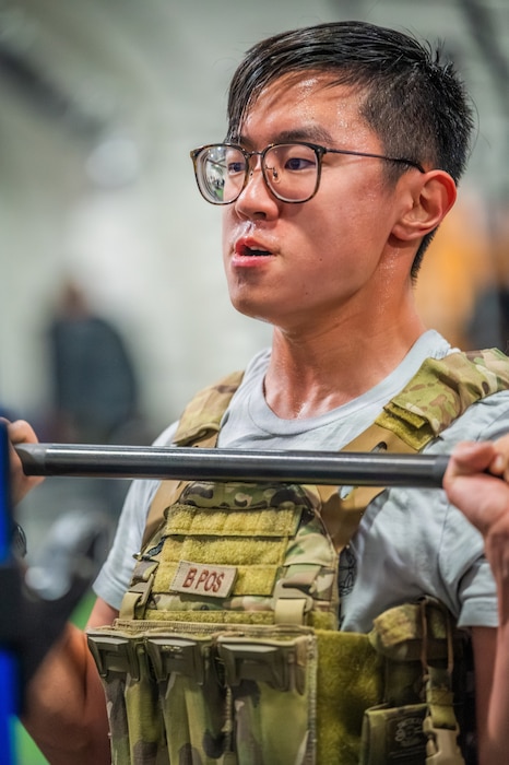 U.S. Air Force Staff Sgt. Jarrett Kim, 56th Civil Engineer Squadron explosive ordnance disposal technician, performs a clean during an annual memorial workout, Dec. 19, 2025, at Luke Air Force Base, Arizona.