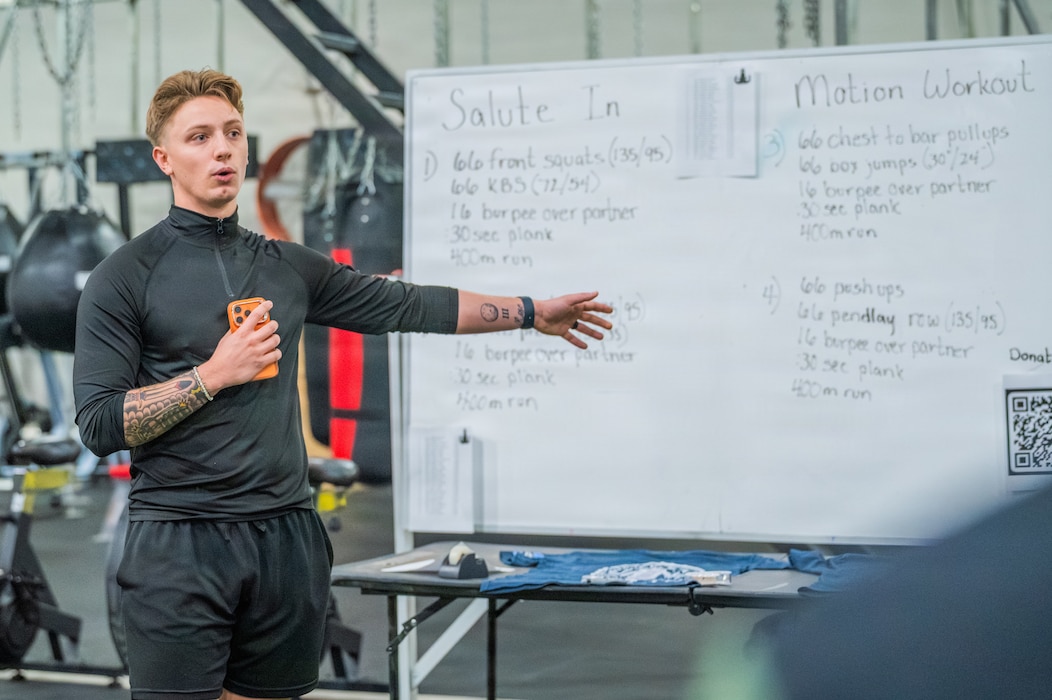 U.S. Air Force Senior Airman Jack Roscoe, 56th Civil Engineer Squadron explosive ordnance disposal technician, briefs Airmen on details regarding an annual memorial workout, Dec. 19, 2025, at Luke Air Force Base, Arizona.