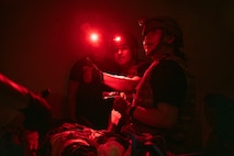 U.S. Air Force Airman 1st Class Rafael Diaz, left, an aerospace medical technician and Staff Sgt. Danielle Dan, right, a health services management craftsman, both assigned to the 99th Medical Group, reassess patient care during the 2025 Diamondback Medic Rodeo at Nellis Air Force Base, Nevada, Dec. 9, 2025.