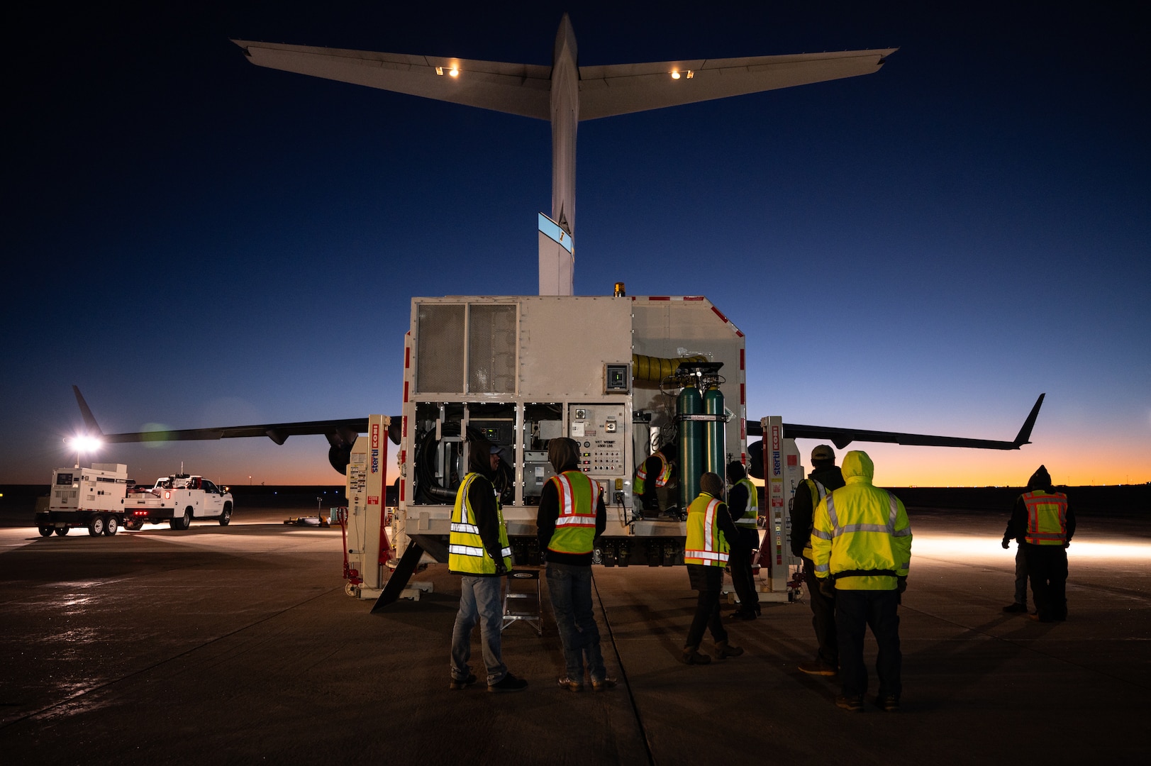 Workers standing in front of a container