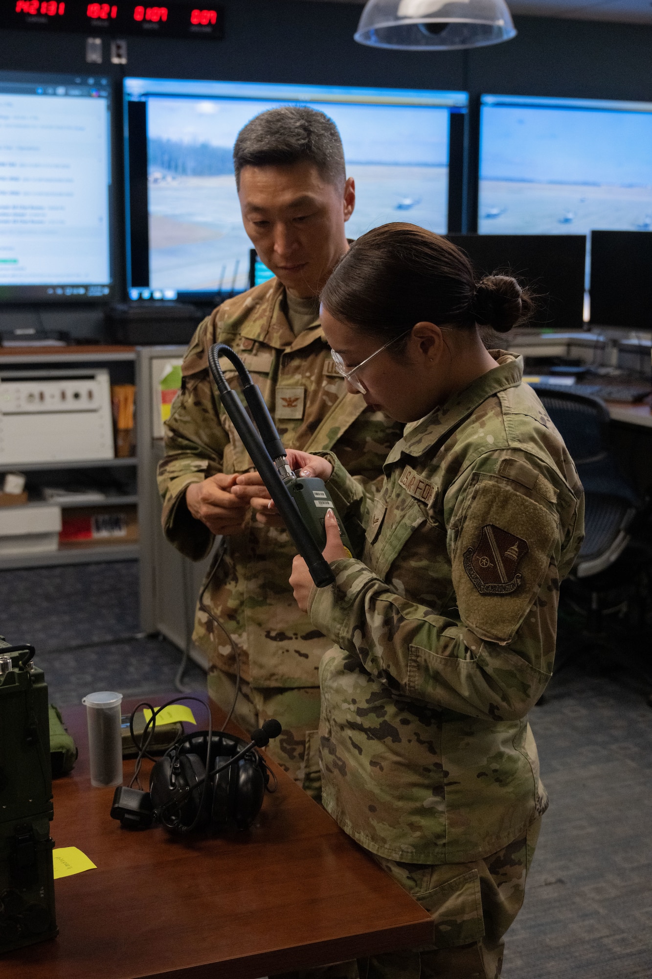 Man watches woman put together a radio.