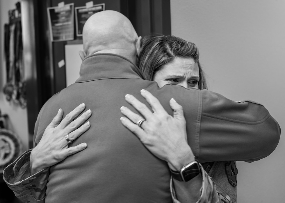 U.S. Air Force Brig. Gen. David Berkland, 56th Fighter Wing commander, hugs Senior Master Sgt. ​​Jennifer Aucoin, 56 Component Maintenance Squadron maintenance training section superintendent, after it was announced Aucoin was selected for promotion to Chief Master Sgt., Jan. 7, 2026, at Luke Air Force Base, Arizona.