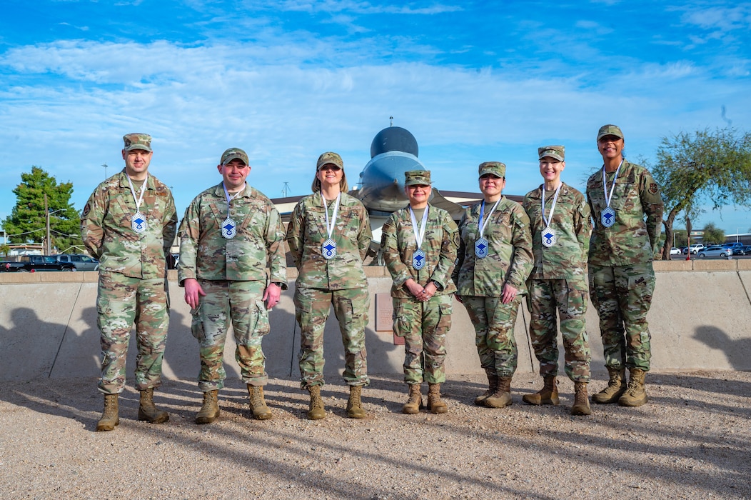 U.S. Air Force Chief Master Sgt. selects, pose for a photo after it was announced they were selected for promotion, Jan. 7, 2026, at Luke Air Force Base, Arizona.