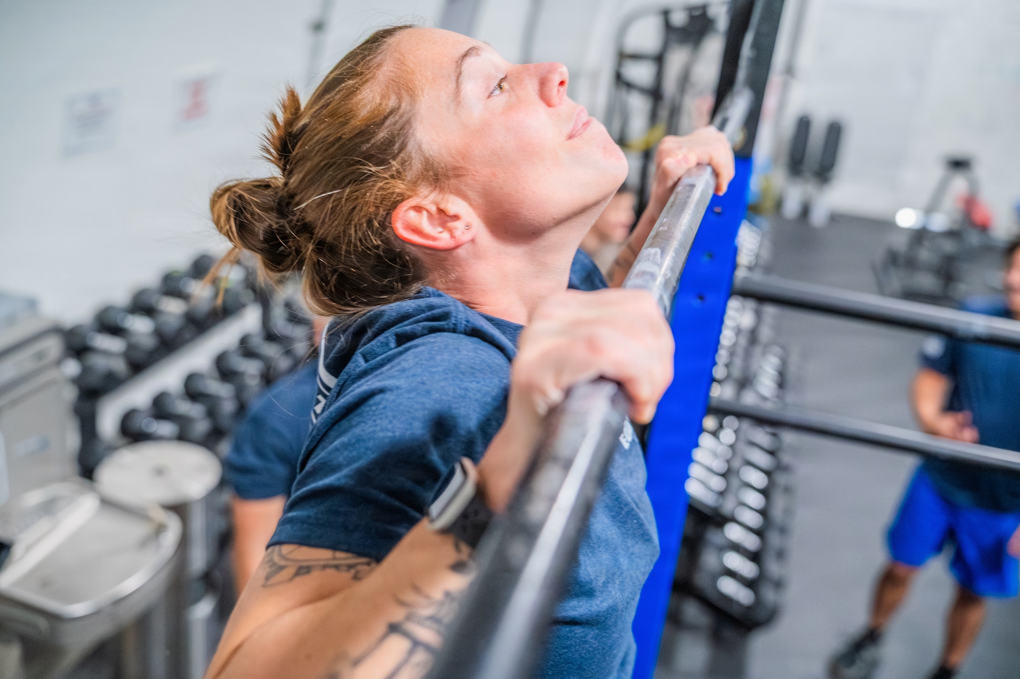 U.S. Air Force Senior Airman Brianna Ochoa, 56th Civil Engineer Squadron explosive ordnance disposal technician, performs pull-ups during an annual memorial workout, Dec. 19, 2025, at Luke Air Force Base, Arizona.