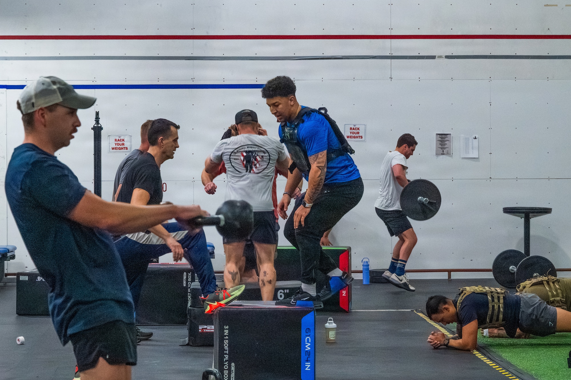 U.S. Air Force Airmen assigned to the 56th Fighter Wing perform exercises during an annual memorial workout, Dec. 19, 2025, at Luke Air Force Base, Arizona.
