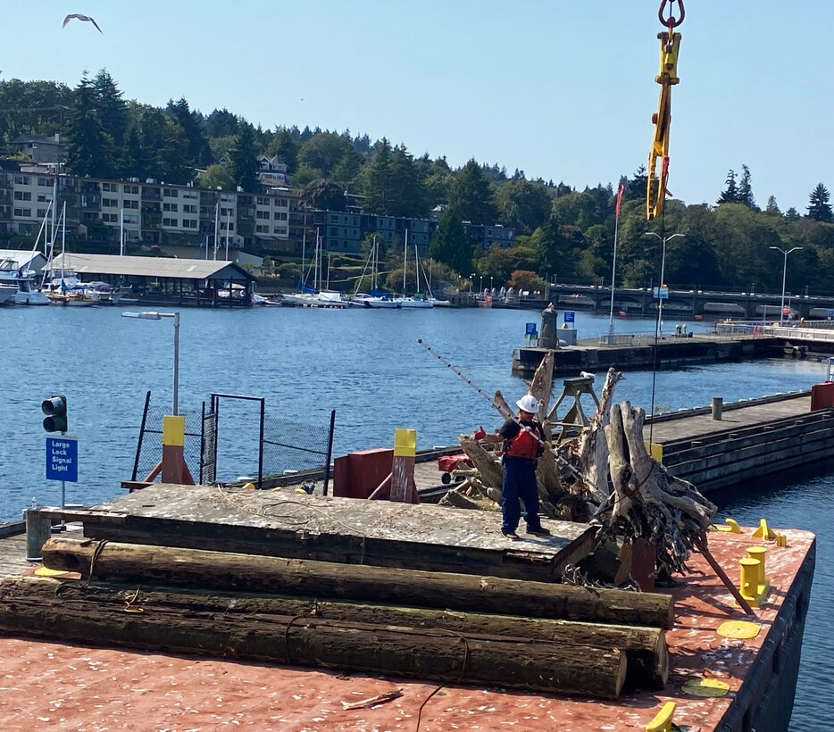 U.S. Army Corps of Engineers' Motor Vessel (MV) Puget crew transfer large woody debris and other obstructions to navigation from the vessel to a barge, located at Lake Washington Ship Canal and Hiram M. Chittenden Locks, Seattle. Seattle District’s Navigation Section removes and disposes derelict objects, waterfront debris and derelict structures, and other sources of drift, that may damage vessels or threaten public health, recreation or the environment at publicly maintained commercial boat harbors.