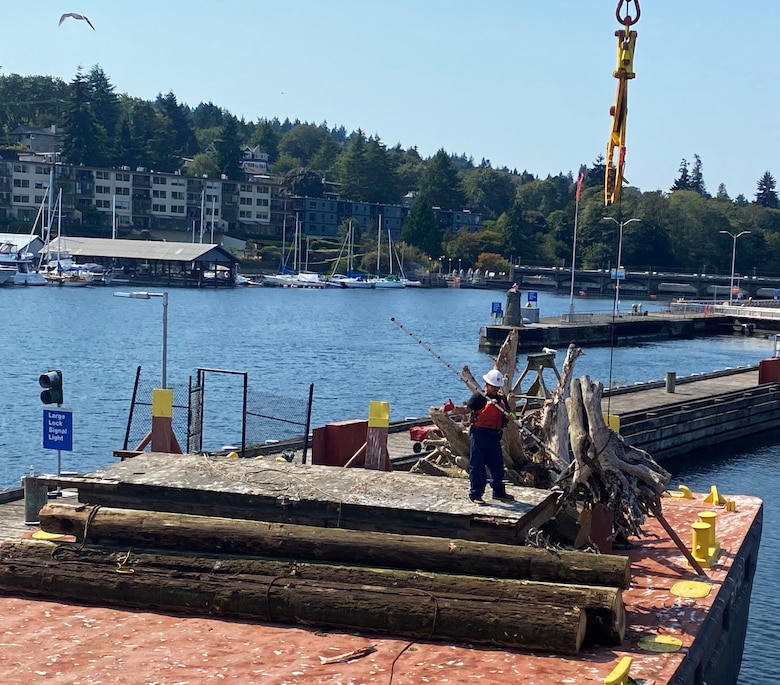 U.S. Army Corps of Engineers' Motor Vessel (MV) Puget crew transfer large woody debris and other obstructions to navigation from the vessel to a barge, located at Lake Washington Ship Canal and Hiram M. Chittenden Locks, Seattle. Seattle District’s Navigation Section removes and disposes derelict objects, waterfront debris and derelict structures, and other sources of drift, that may damage vessels or threaten public health, recreation or the environment at publicly maintained commercial boat harbors.