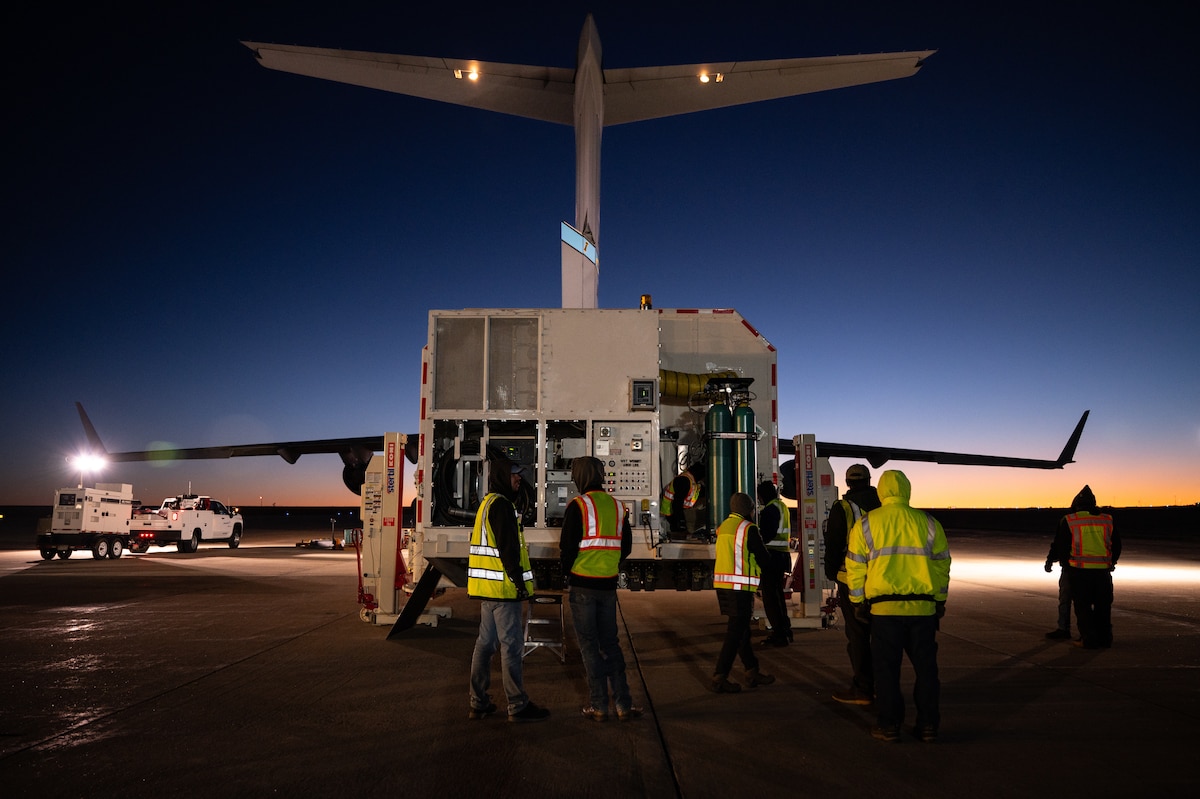 Workers standing in front of a container
