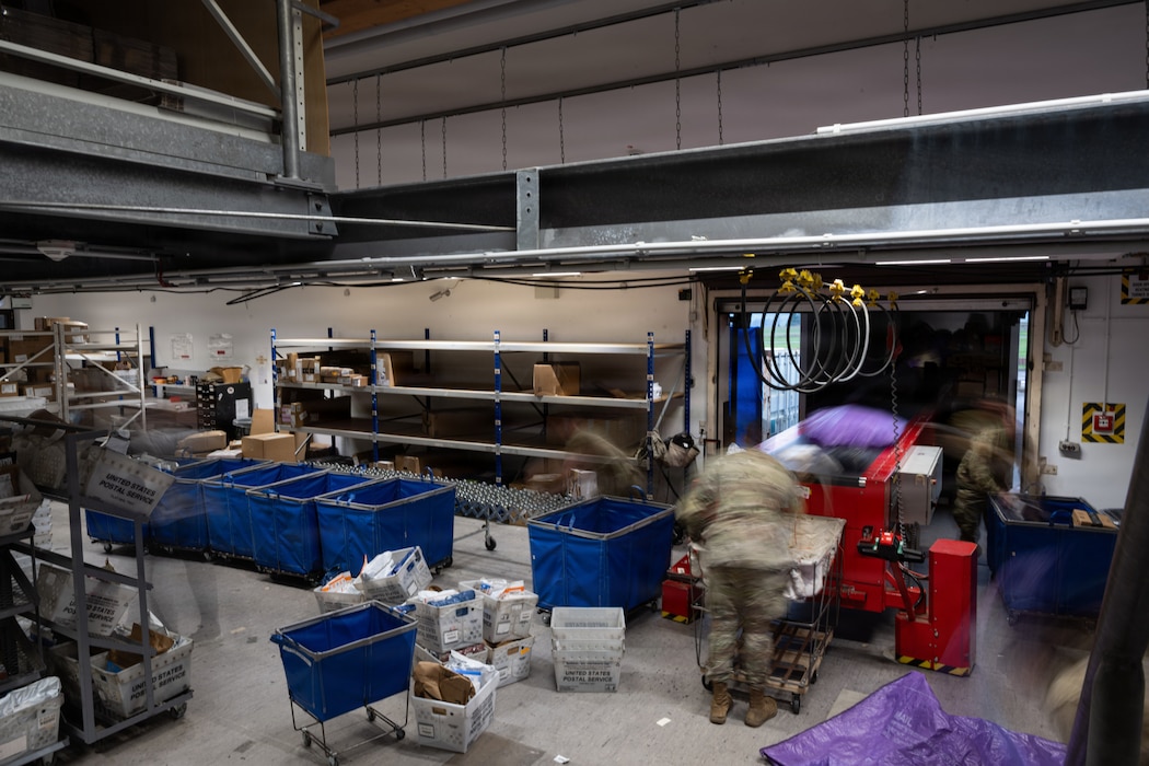 U.S. Air Force Airmen sort and distribute packages and mail.
