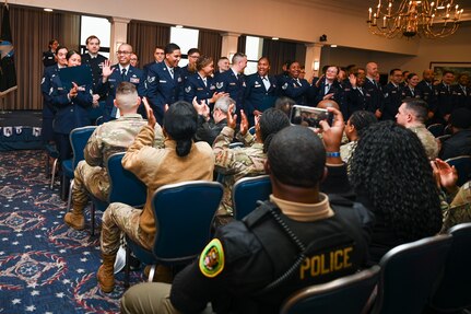 Friends and family cheer at the conclusion of the Community College of the Air Force graduation at Joint Base Anacostia-Bolling, Washington, D.C., Jan. 9, 2026. The JBAB command team presented the degrees to 112 Airman and Guardian recipients from JBAB, Joint Base Andrews, Md., and the Pentagon (U.S. Air Force photo by Airman 1st Class Shanel Toussaint)