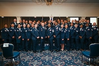 The graduates from the Community College of the Air Force gather with Joint Base Anacostia-Bolling and Joint Base Andrews leadership during the graduation ceremony at JBAB, Washington, D.C., Jan. 9, 2026. One hundred twelve Airmen and Guardians graduated during the ceremony from JBAB, Joint Base Andrews, Md., and the Pentagon. (U.S. Air Force photo by Airman 1st Class Shanel Toussaint)