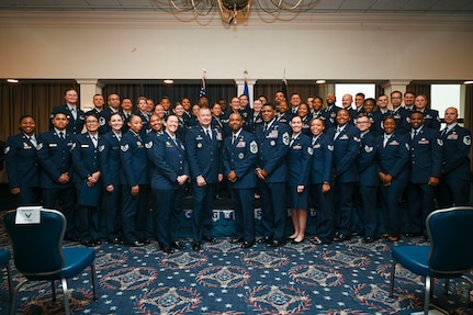 The graduates from the Community College of the Air Force gather with Joint Base Anacostia-Bolling and Joint Base Andrews leadership during the graduation ceremony at JBAB, Washington, D.C., Jan. 9, 2026. One hundred twelve Airmen and Guardians graduated during the ceremony from JBAB, Joint Base Andrews, Md., and the Pentagon. (U.S. Air Force photo by Airman 1st Class Shanel Toussaint)
