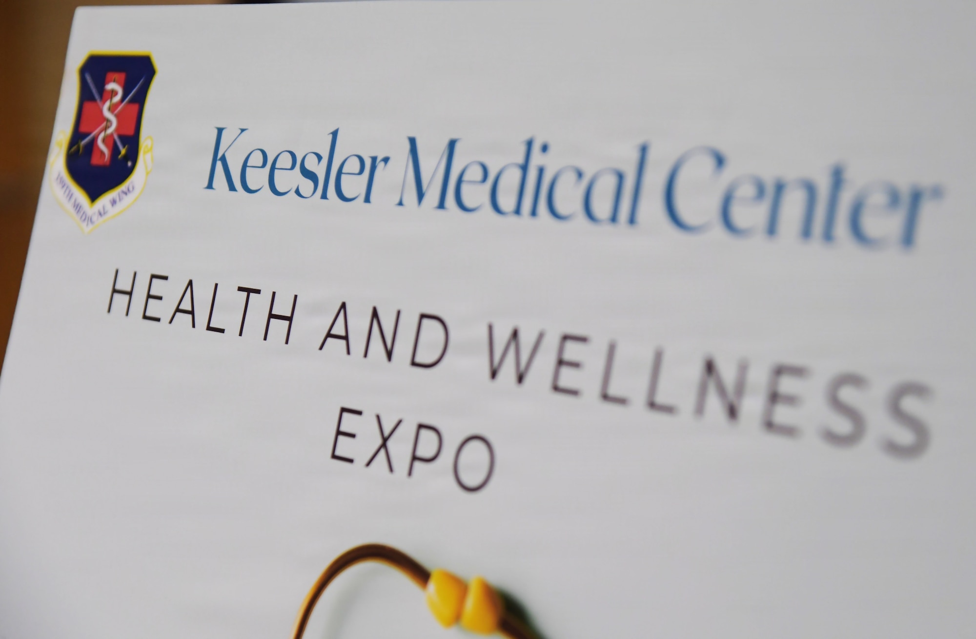 A Keesler Medical Center Health and Wellness Expo sign is on display.