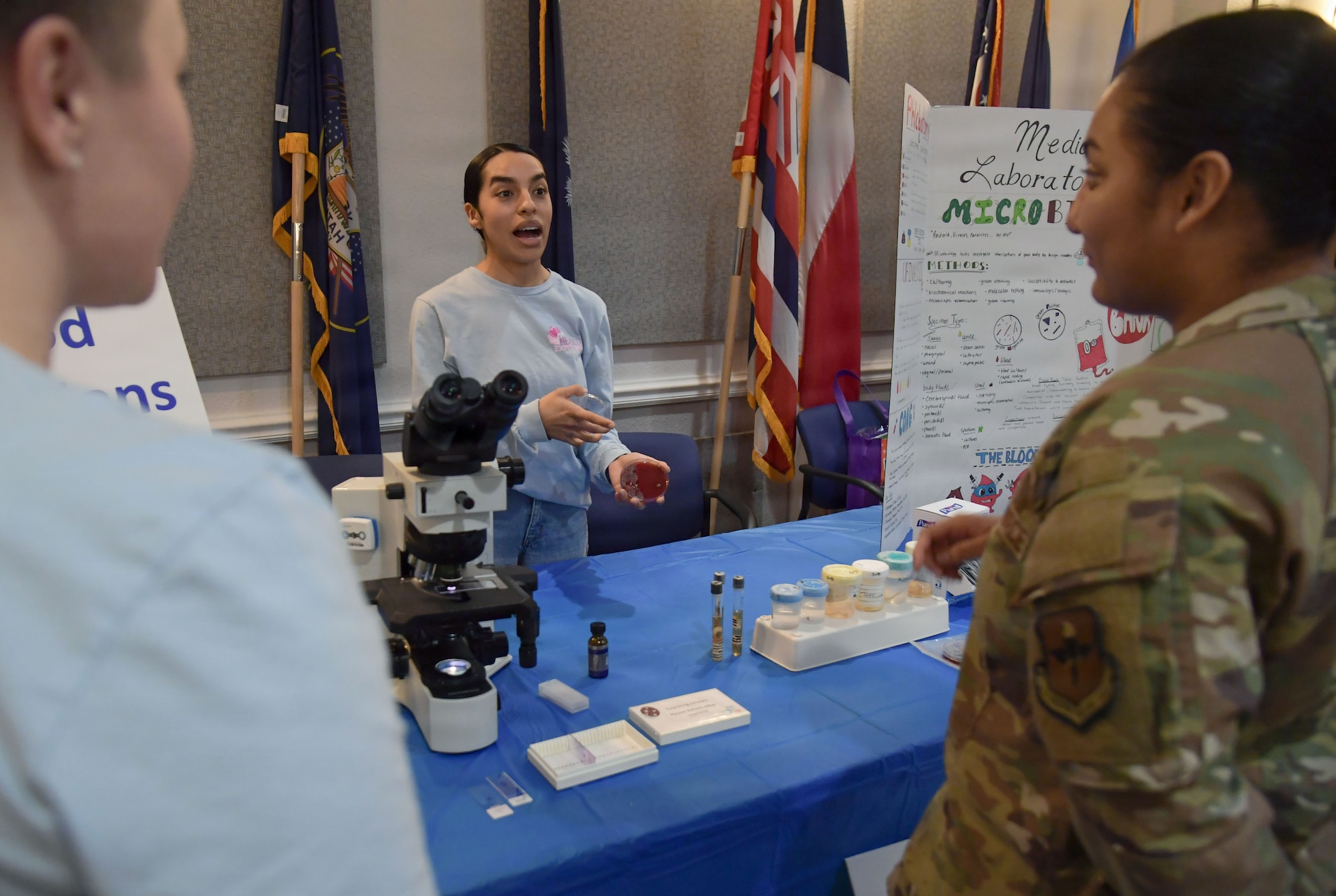A woman shows others the inside of a culture sample.