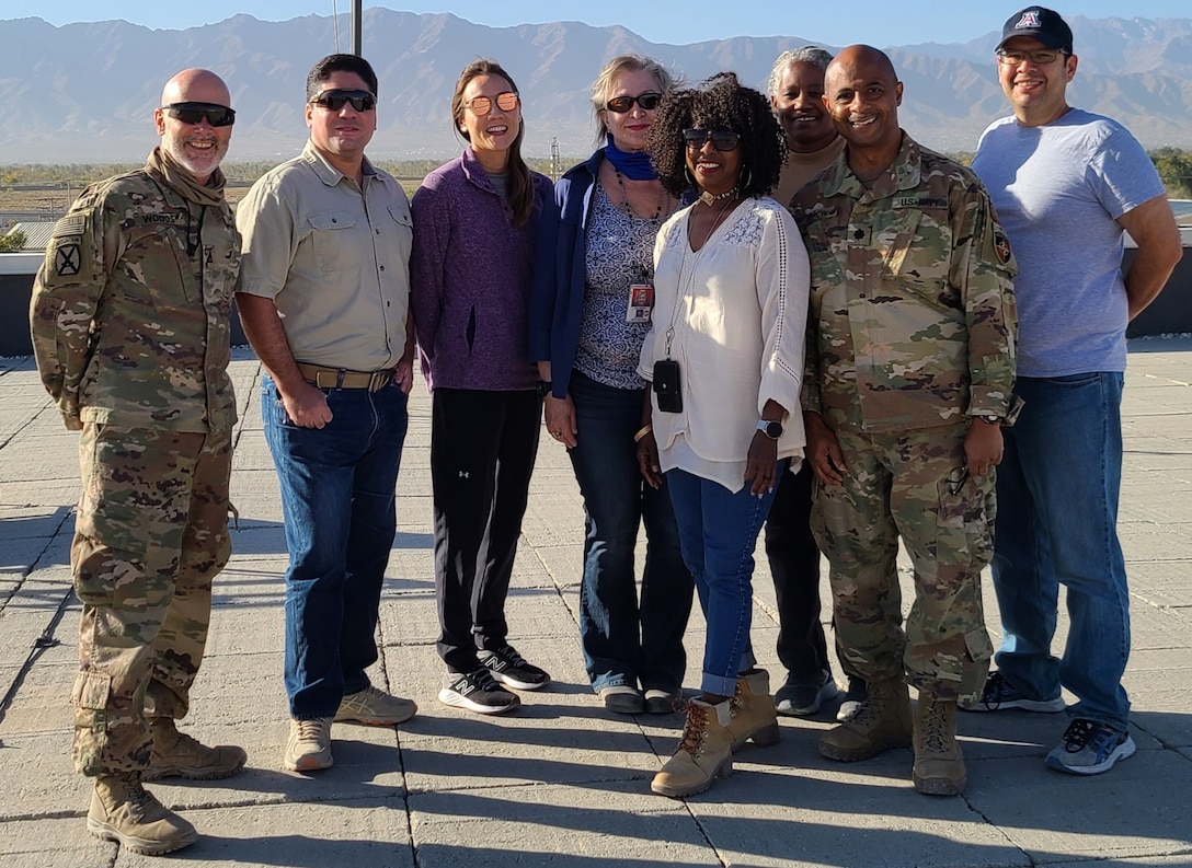 A group of people standing posing for a group shot.