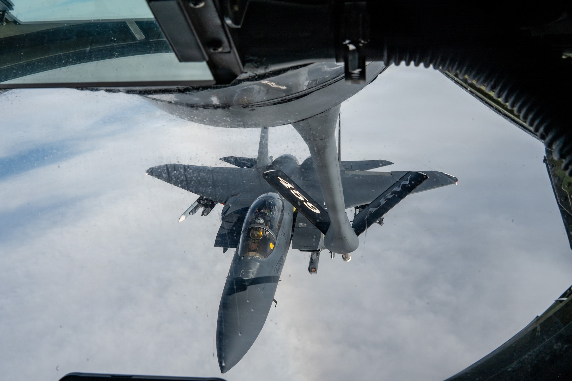 A KC-135 Stratotanker, assigned to the 459th Air Refueling Wing, Maryland, refuels an F-15E Strike Eagle, assigned to the 4th Fighter Wing, North Carolina, over the southeastern United States, December 18, 2025. The KC-135 is the U.S. Air Force's core aerial refueling platform, extending the global reach of the Air Force, Navy, Marine Corps, and allied nations. (U.S. Air Force photo by Tech. Sgt. Tiffany A. Emery)