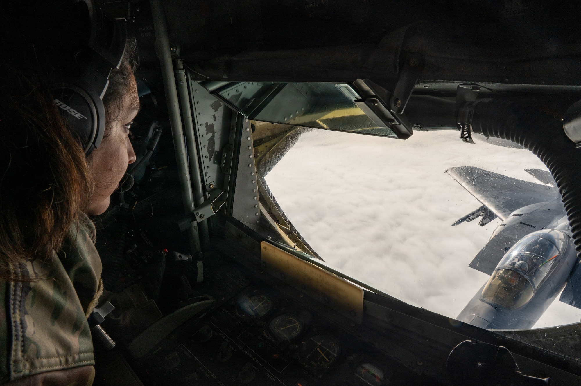 U.S. Air Force Tech. Sgt Sandra Henriquez, a boom operator with the 459th Air Refueling Wing, Maryland, operates the boom of a KC-135 Stratotanker over the southeastern United States December 18, 2025. The KC-135 is the U.S. Air Force's core aerial refueling platform, extending the global reach of the Air Force, Navy, Marine Corps, and allied nations. (U.S. Air Force photo by Tech. Sgt. Tiffany A. Emery)