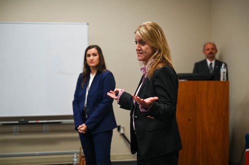 Women speaks to room.