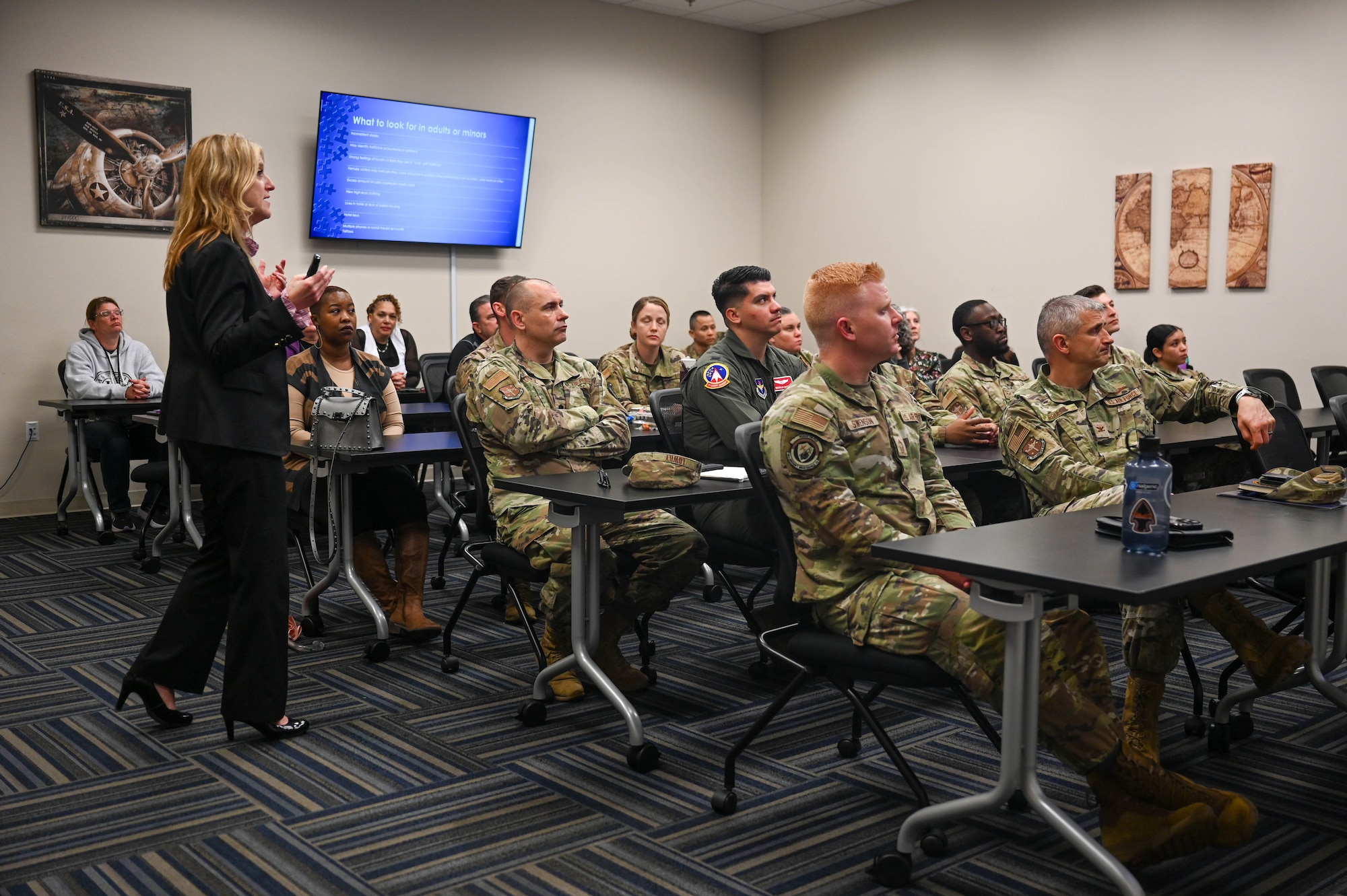 Woman speaks to a classroom of service members.
