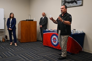 A man speaks to classroom.