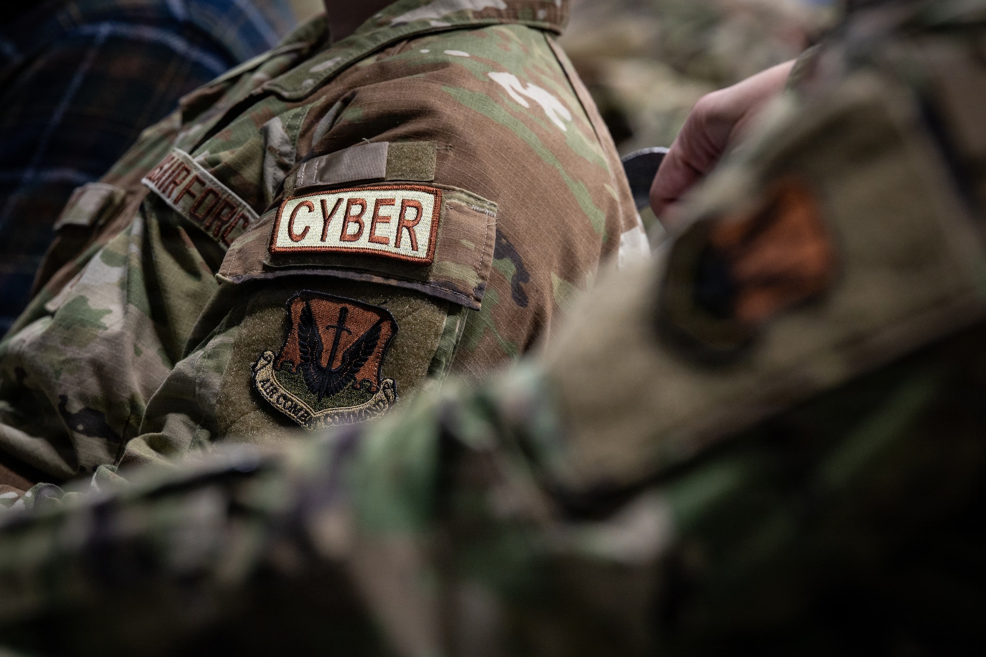 A U.S. Air National Guardsman assigned to the 119th Cyberspace Operations Squadron is seen wearing a cyber operations patch during the unit’s 75th anniversary ceremony at McGhee Tyson Air National Guard Base, Tennessee, Jan. 11, 2026.