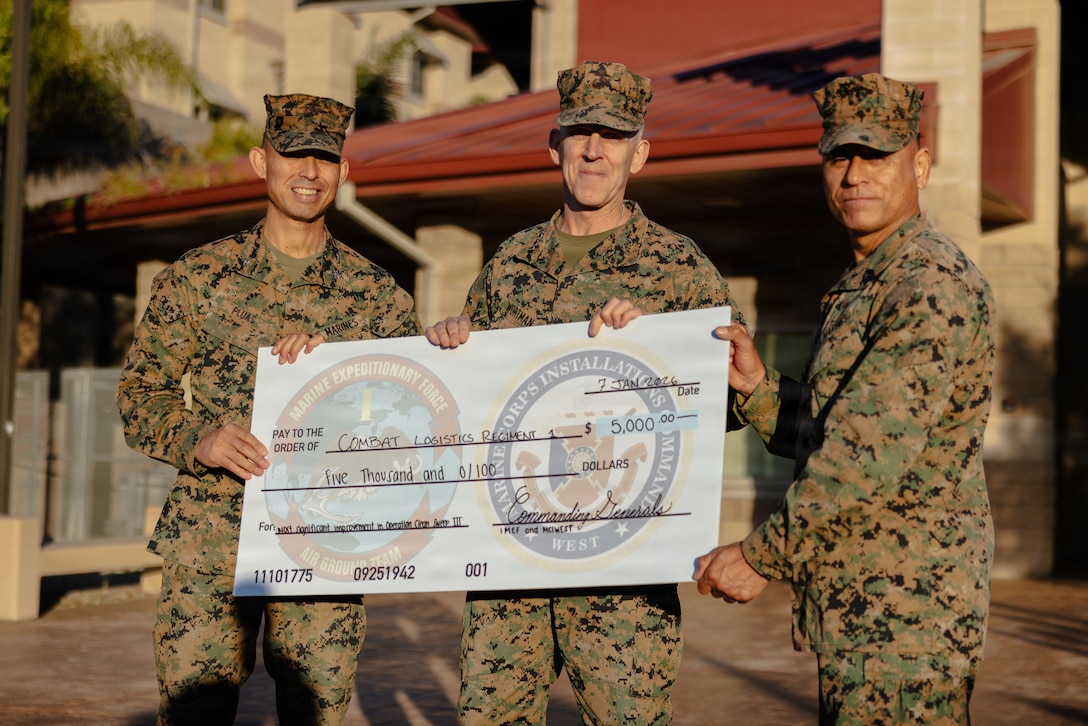 U.S. Marine Corps Col. Patrick Pluas, left, the commanding officer of Combat Logistics Regiment 1, 1st Marine Logistics Group, Lt. Gen. Christian F. Wortman, center, the commanding general of I Marine Expeditionary Force, and Sgt. Maj. Hector Rivera, right, the senior enlisted advisor of CLR-1, 1st MLG, pose for a photo during an award ceremony for Operation Clean Sweep III on Marine Corps Base Camp Pendleton, California, Jan. 7, 2026. CLR-1 was recognized as the most improved unit during OCS III, sustaining and demonstrating increased discipline showing measurable improvements throughout the operation. (U.S. Marine Corps photo by Lance Cpl. Alan Gomez)