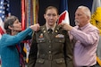 Anne and David Pampuch pin silver eagle rank on their daughter, Col. Jennifer S. Pampuch Borden, U.S. Army Financial Management Command Reserve Component senior advisor and U.S. Army Reserve Medical Command assistant chief of staff for resource management, during her promotion ceremony at the Maj. Gen. Emmett J. Bean Federal Center in Indianapolis, Jan. 9, 2026. Since her graduation for the U.S. Military Academy at West Point, Pampuch Borden served in all three Army components as both a military police officer and finance officer. (U.S. Army photo by Mark R. W. Orders-Woempner)