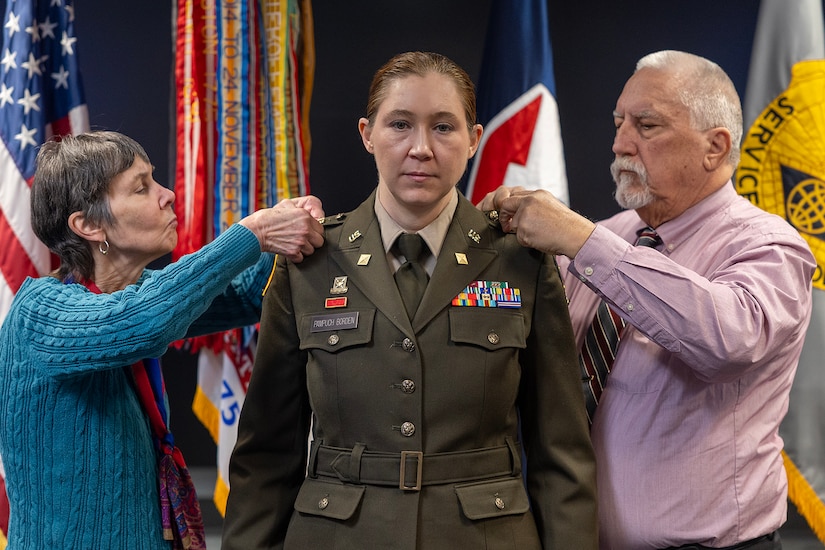 Anne and David Pampuch pin silver eagle rank on their daughter, Col. Jennifer S. Pampuch Borden, U.S. Army Financial Management Command Reserve Component senior advisor and U.S. Army Reserve Medical Command assistant chief of staff for resource management, during her promotion ceremony at the Maj. Gen. Emmett J. Bean Federal Center in Indianapolis, Jan. 9, 2026. Since her graduation for the U.S. Military Academy at West Point, Pampuch Borden served in all three Army components as both a military police officer and finance officer. (U.S. Army photo by Mark R. W. Orders-Woempner)