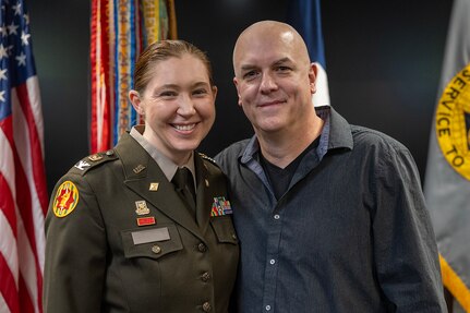 Col. Jennifer S. Pampuch Borden, U.S. Army Financial Management Command Reserve Component senior advisor and U.S. Army Reserve Medical Command assistant chief of staff for resource management, poses for a photo with her husband, Michael, after her promotion ceremony at the Maj. Gen. Emmett J. Bean Federal Center in Indianapolis, Jan. 9, 2026. Since her graduation for the U.S. Military Academy at West Point, Pampuch Borden served in all three Army components as both a military police officer and finance officer. (U.S. Army photo by Mark R. W. Orders-Woempner)