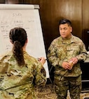 Maj. Jessica Jamous and Senior Master Sgt. Jan Gawaran Guinto, U.S. Air Force Airmen assigned to the 655th Intelligence, Surveillance, and Reconnaissance (ISR) Wing, discuss aligning ISR Division capabilities and functions with Pacific Air Force (PACAF) intelligence units on Sept. 8. 2025.