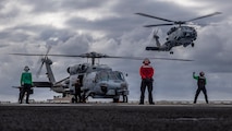 An MH-60R Sea Hawk, attached to Helicopter Maritime Strike Squadron (HSM) 71, prepares to land on the flight deck of Nimitz-class aircraft carrier USS Abraham Lincoln (CVN 72) in the South China Sea, Jan. 8, 2026. The Abraham Lincoln Carrier Strike Group is underway conducting routine operations in the U.S. 7th Fleet area of operations. Units assigned to U.S. 7th Fleet conduct regular Indo-Pacific patrols to deter aggression, strengthen alliances and partnerships, and advance peace through strength. (U.S. Navy photo by Mass Communication Specialist Seaman Daniel Kimmelman)