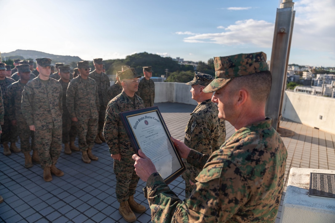 U.S. Marine Corps Sgt. Maj. Christopher Adams, sergeant major of III Marine Expeditionary Force, reads a promotion warrant to Master Sgt. Christopher McCullar during McCullar’s redesignation to first sergeant on Camp Foster, Okinawa, Japan, Jan. 9, 2026. McCullar was selected for a lateral move to first sergeant under the new E-8 transfer pilot initiative. McCullar will take over as the senior enlisted advisor for Communications Company, 3rd Marine Littoral Regiment, 3rd Marine Division. (U.S. Marine Corps photo by Cpl. Jeremiah Barksdale)