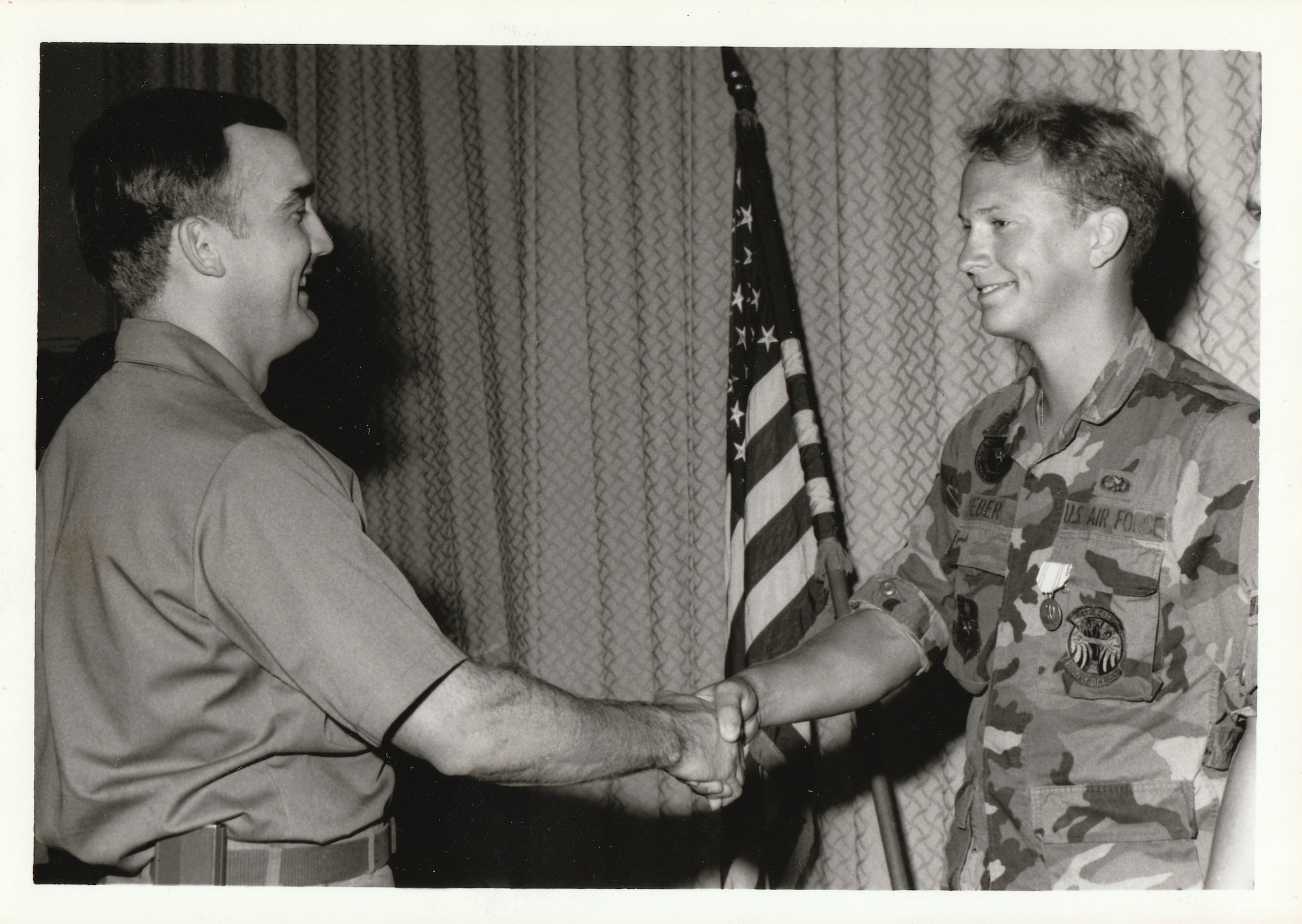 David N. Weber (right), an enlisted U.S. Air Force Airman, receives recognition during a presentation ceremony, circa late 1980s. Weber served as a tactical aircraft maintenance specialist and supported aircraft operations during his active-duty service. (Courtesy Photo)