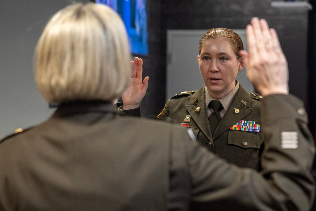 Col. Michelle M. Williams, U.S. Army Financial Management Command commander, administers an oath of office to Col. Jennifer S. Pampuch Borden, USAFMCOM Reserve Component senior advisor and U.S. Army Reserve Medical Command assistant chief of staff for resource management, during Pampuch Borden’s promotion ceremony at the Maj. Gen. Emmett J. Bean Federal Center in Indianapolis, Jan. 9, 2026. Since her graduation for the U.S. Military Academy at West Point, Pampuch Borden served in all three Army components as both a military police officer and finance officer. (U.S. Army photo by Mark R. W. Orders-Woempner)