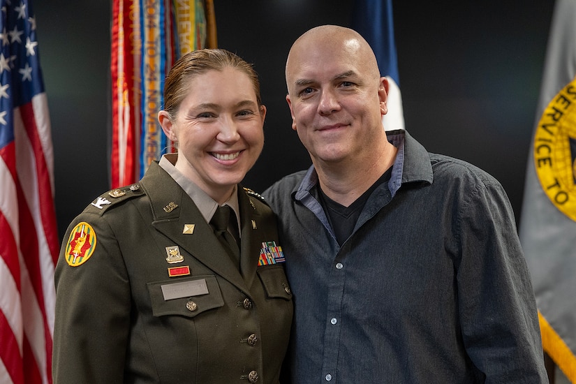 Col. Jennifer S. Pampuch Borden, U.S. Army Financial Management Command Reserve Component senior advisor and U.S. Army Reserve Medical Command assistant chief of staff for resource management, poses for a photo with her husband, Michael, after her promotion ceremony at the Maj. Gen. Emmett J. Bean Federal Center in Indianapolis, Jan. 9, 2026. Since her graduation for the U.S. Military Academy at West Point, Pampuch Borden served in all three Army components as both a military police officer and finance officer. (U.S. Army photo by Mark R. W. Orders-Woempner)