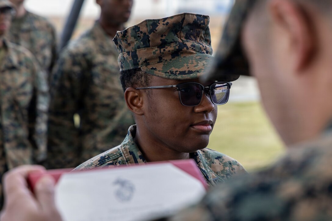 U.S. Marine Corps Cpl. Sydney Smalls, an administrative clerk with Marine Aircraft Group 12, 1st Marine Aircraft Wing, stands at attention during her promotion ceremony Marine Corps Air Station Iwakuni, Japan, Dec. 3, 2025. Meritorious promotion ceremonies are a significant achievement in a service member’s career and are a testament to their commitment, mastery of duties and skills, and leadership capabilities. Marines take on greater responsibilities as Non-Commissioned Officers after showing exemplary leadership skills. Smalls is a native of New York. (U.S. Marine Corps photo by Cpl. Chloe Johnson)