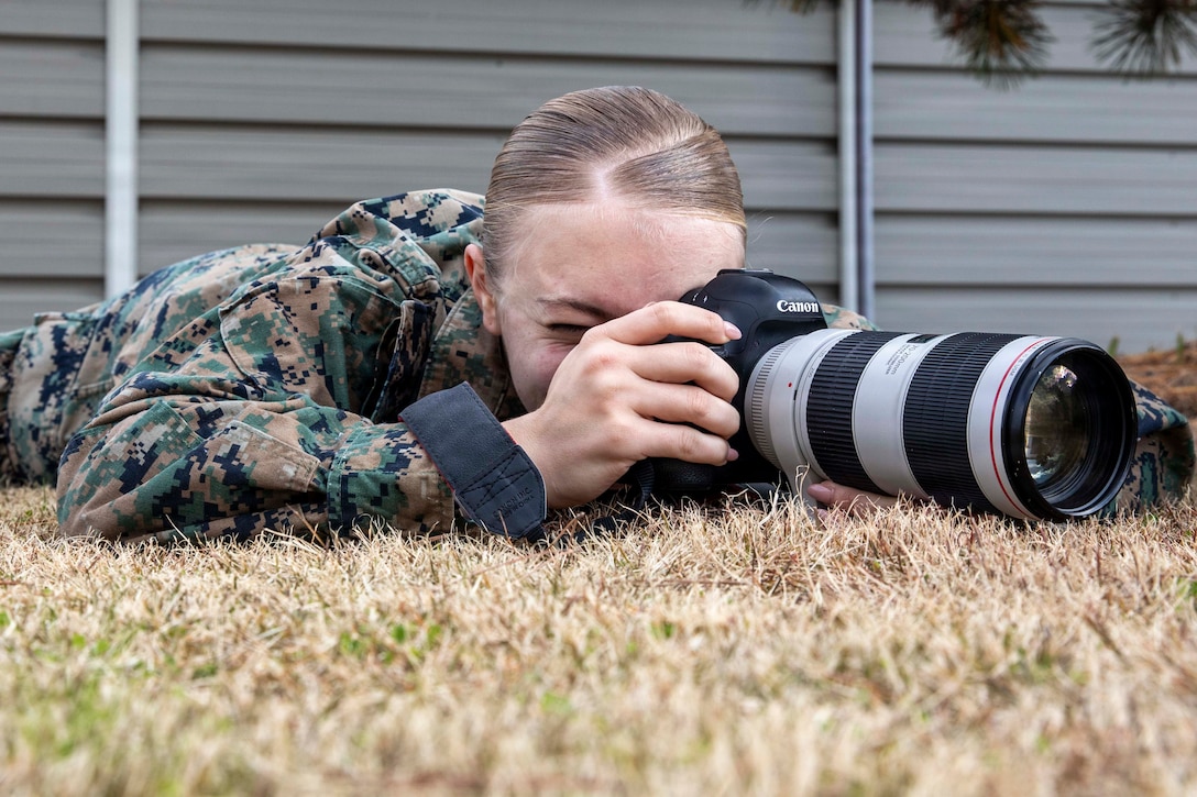 U.S. Marine Corps Lance Cpl. Cecilia Campbell, a combat videographer with Marine Aircraft Group 12, 1st Marine Aircraft Wing, takes a photo at Marine Corps Air Station Iwakuni, Japan, Dec. 15, 2025. During participation in the Marine Corps Instillations Pacific hosted course, she received first place in the photo story and b-roll package portions. Campbell is a native of Virginia. (U.S. Marine Corps photo by Lance Cpl. David Getz)