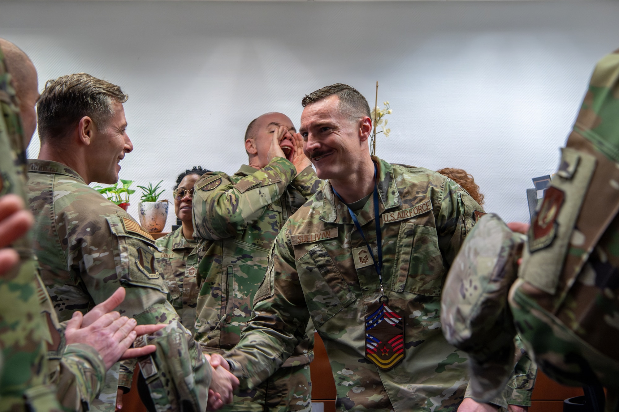 U.S. Air Force Senior Master Sgt. Brandon Sullivan, 86th Logistics Group headquarters Special Operations Command forward area refueling point program manager, shakes hands with fellow Airmen after being notified of his selection to chief master sergeant at Ramstein Air Base, Germany, Jan. 8, 2026.