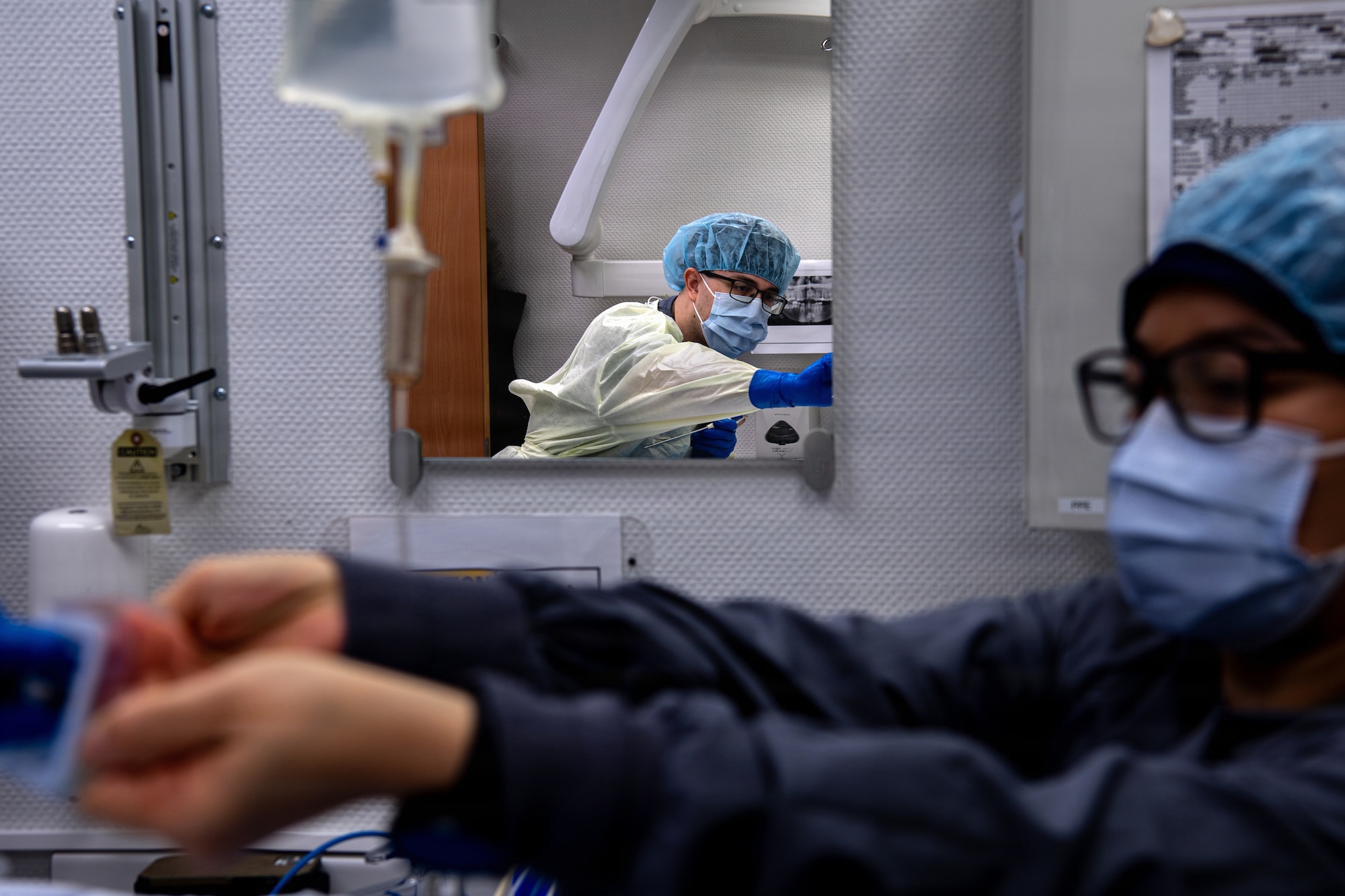U.S. Air Force Staff Sgt. Anutsara Wilson, right, 86th Dental Squadron non-commissioned officer in charge of emergency management, hands a medical instrument to Senior Airman Devon Sharp, 86th DS oral surgery technician during a tooth extraction at Ramstein Air Base, Germany, Jan. 13, 2026.