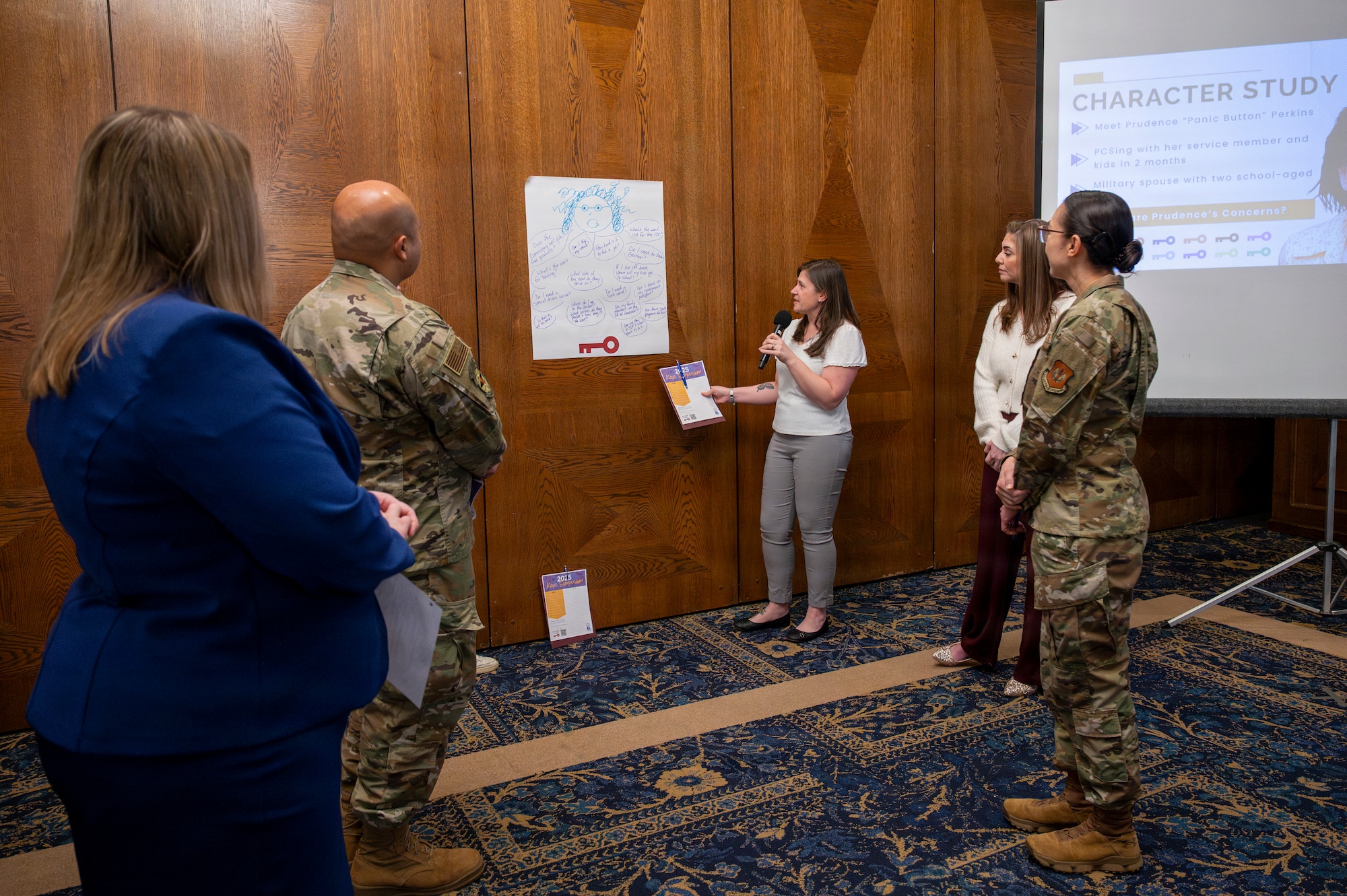 Lisah Frankland, 24th Intelligence Squadron key support liaison, presents her group's insights on common questions people have when arriving to Germany during the 2026 Keys Symposium at Ramstein Air Base, Germany, Jan. 13, 2026.