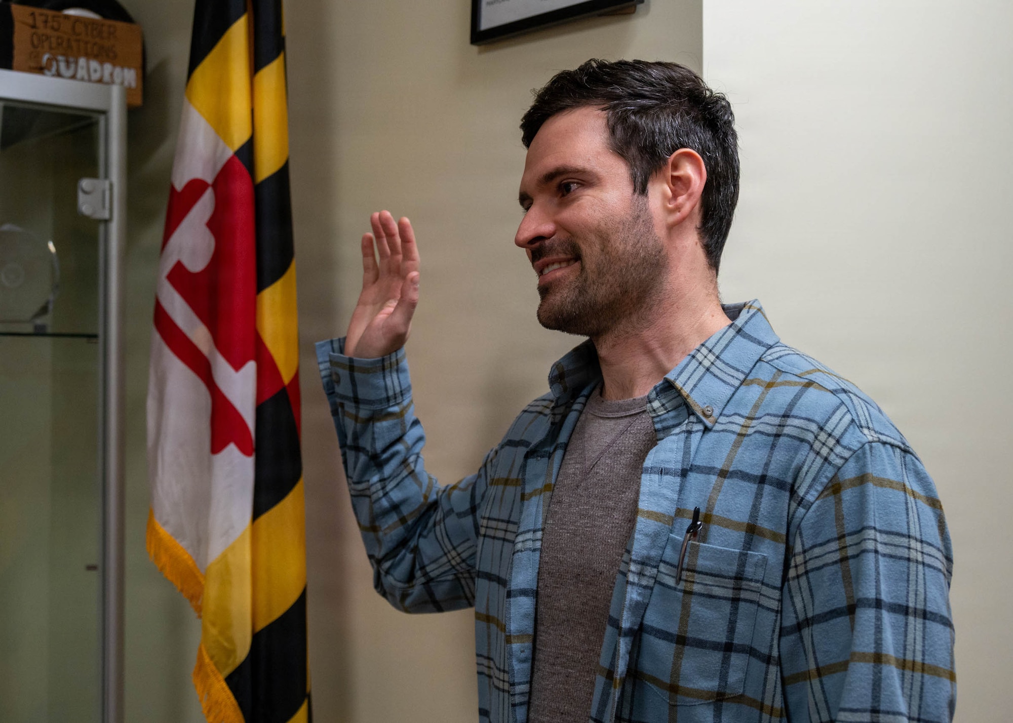 Maryland Air National Guard Chief Warrant Officer 2 Brian Ruzin, exploitation analyst for the 175th Cyberspace Operations Squadron, is sworn into the Maryland Air National Guard transferring from the U.S. Navy at the Maryland Air National Guard Cyberspace Operations building on Fort George G. Meade, Maryland, December 19, 2025.