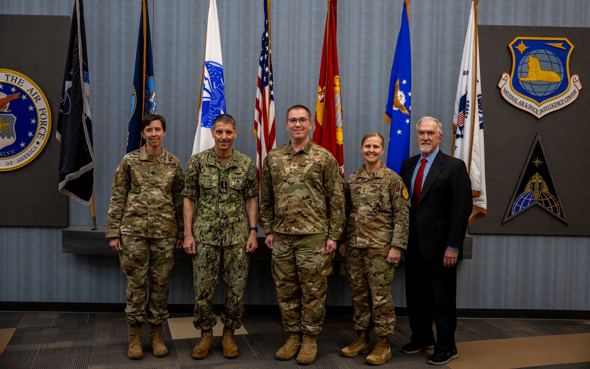 U.S. Navy Adm. Rich Correll (middle left), commander, U.S. Strategic Command, U.S. Army Command Sgt. Maj. Jo Naumann (far left), command senior enlisted leader, USSTRATCOM, and Richard Chancellor (far right), deputy director, USSTRATCOM, gather for a group photo with U.S. Air Force Col. Shaun Easley (middle), deputy commander, National Air and Space Intelligence Center, and Chief Master Sgt. Tabatha Sanders (middle right), command chief, NASIC, during a visit to Wright-Patterson Air Force Base, Ohio, Jan. 12, 2026. USSTRATCOM is a global warfighting combatant command whose mission is to deter strategic attack and employ forces, as directed, to guarantee the security of the U.S. and its allies.