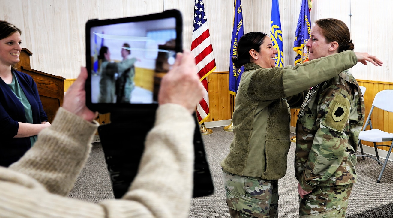 Illinois Army National Guard Maj. Jennifer Hillyer embraces her friend, Sgt. 1st Class Misty Mesecher, after her retirement ceremony on Jan. 9.